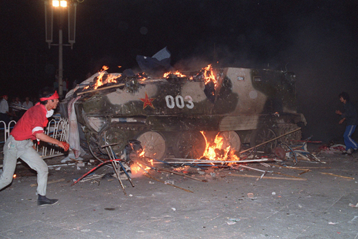 An armoured personnel carrier is in flames as stud