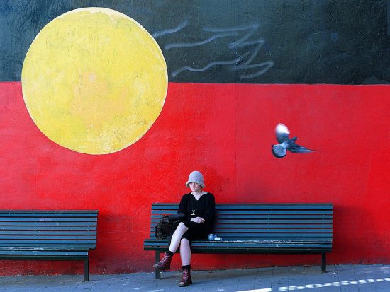 A mural of the Aboriginal flag adorn a w